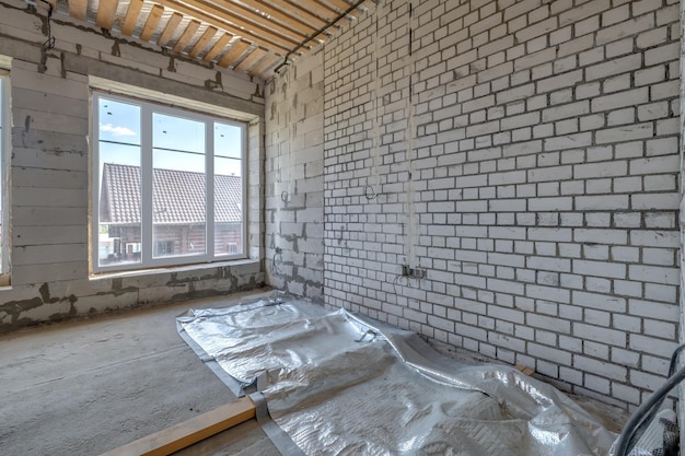 Empty interior in house without repair with white silicate brick walls