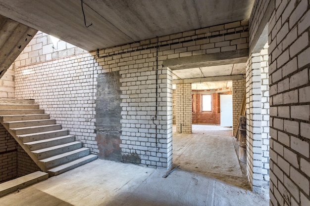 Empty interior in house without repair with white silicate brick walls