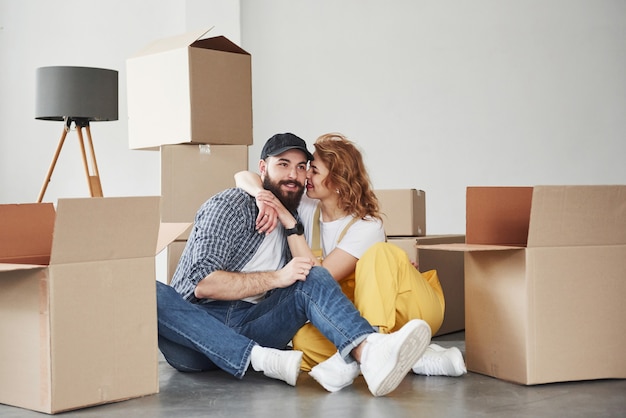 Empty interior, this is not for long. Happy couple together in their new house. Conception of moving