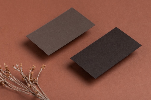 Empty invitation card or business card mockup on a brown table