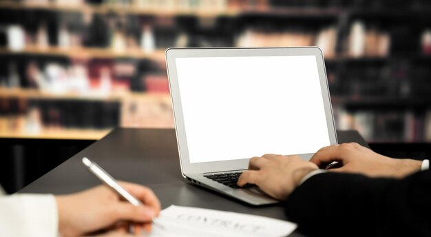 Empty laptop computer screen for astute design mockup on a table in library