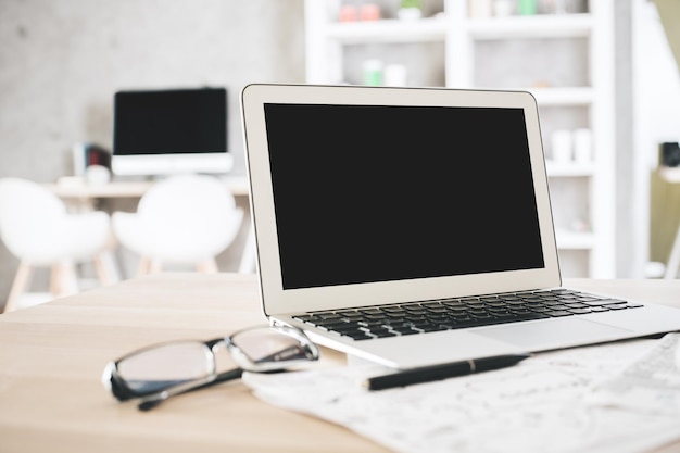 Empty laptop and glasses