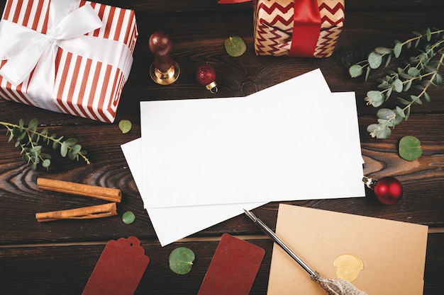 Empty letter with a feather on old  wooden  decorated with christmas objects