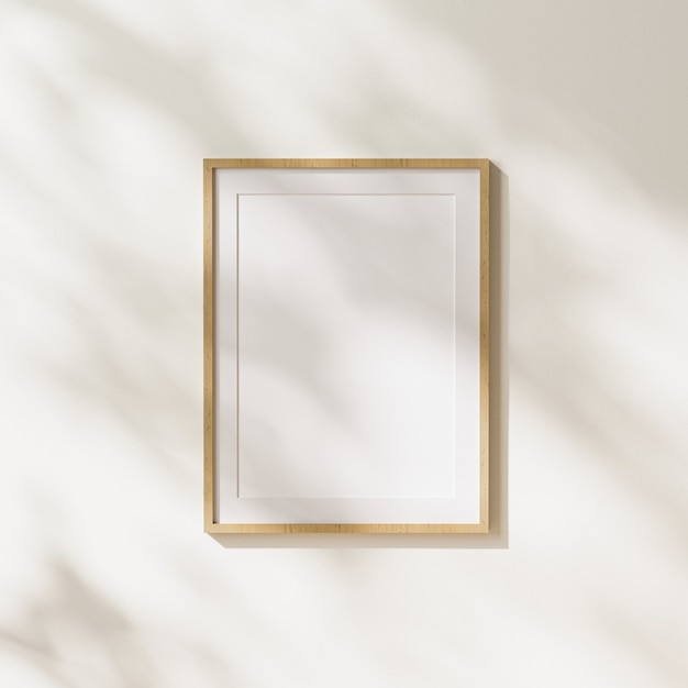 Empty  light wood vertical poster frame with mat mock up with leaves shadows and sunlight on white wall background, 3d rendering