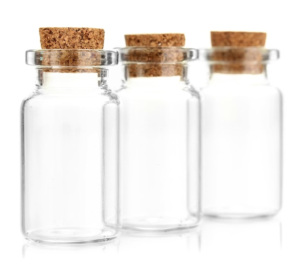 Photo empty little bottles with cork stopper isolated on white