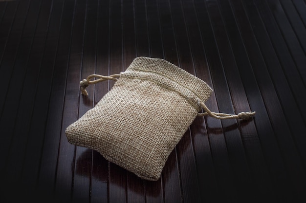 Photo empty little sack made of linen on canvas background