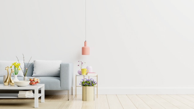 Empty living room with blue sofa, plants and table on empty white wall