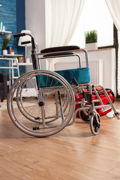 Empty living room with no one in it with medical wheelchair\
next to red physical therapist rehab bag ready for specialized\
physical therapy session. support center for people with\
disabilities.