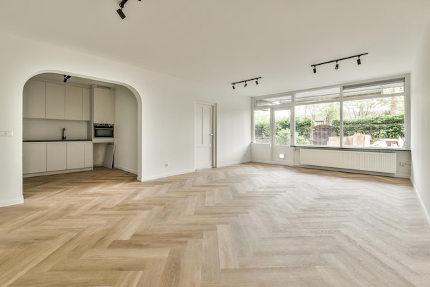 Empty living room with open kitchen