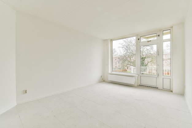 An empty living room with white walls and a window