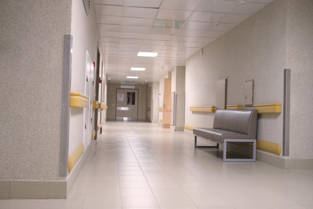 An empty long gray corridor of an building nobody