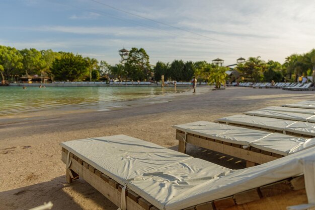 Empty lounge chairs in front of a pool