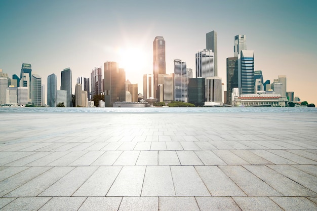 Empty marble floor with modern city skyline and sea background .