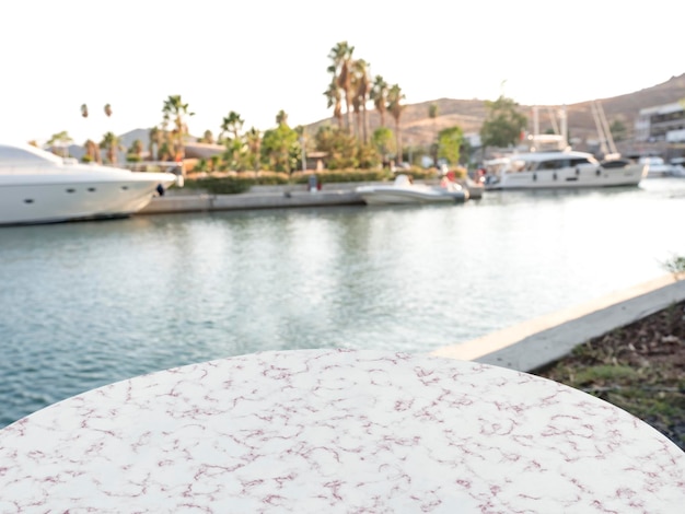 Empty marble table in front of marina background