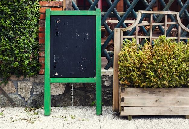 Empty menu board on street on the pub or restaurant background. Beauty and minimalism style