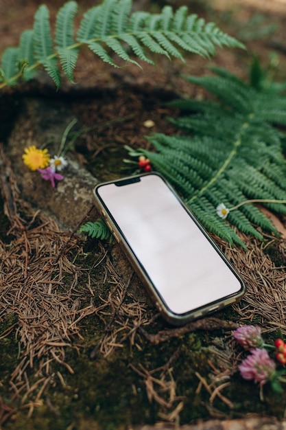 empty mobile phone mockup on the background of nature in the forest