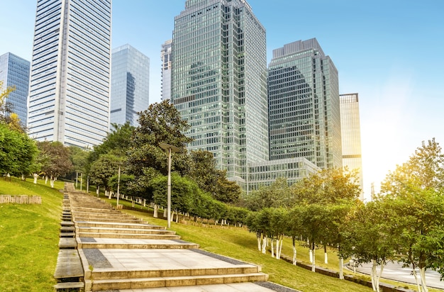 empty, modern square and skyscrapers under sunbeam