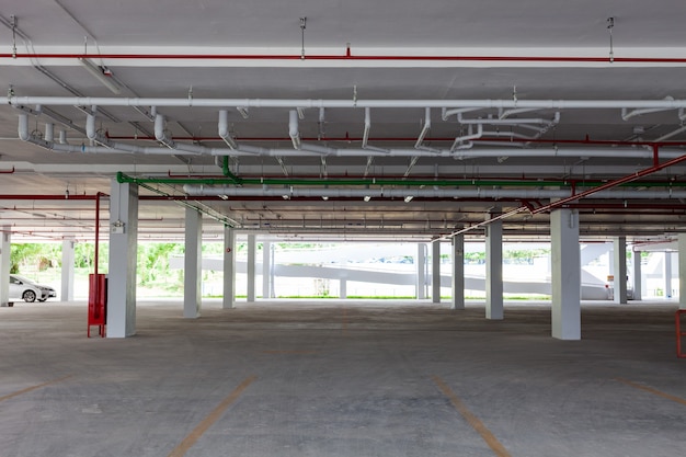 Empty new parking garage underground interior in apartment or business building office and supermarket store.
