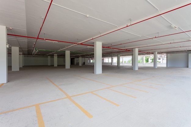 Empty new parking garage underground interior in apartment or business building office and supermarket store.