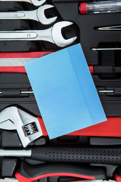 Photo empty note with instruments on the toolbox