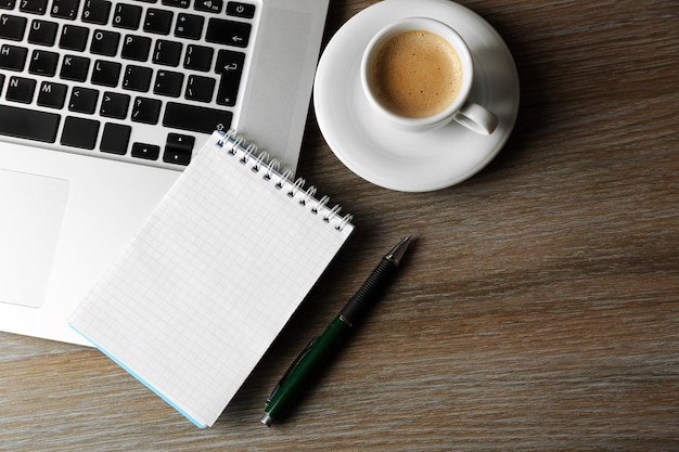 Empty notebook on laptop keyboard on light background