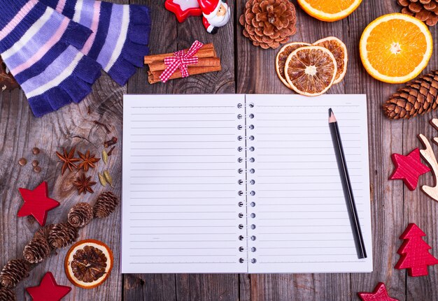 Photo empty notebook in a line and a black pencil