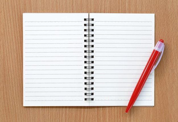 Empty notebook and red pen