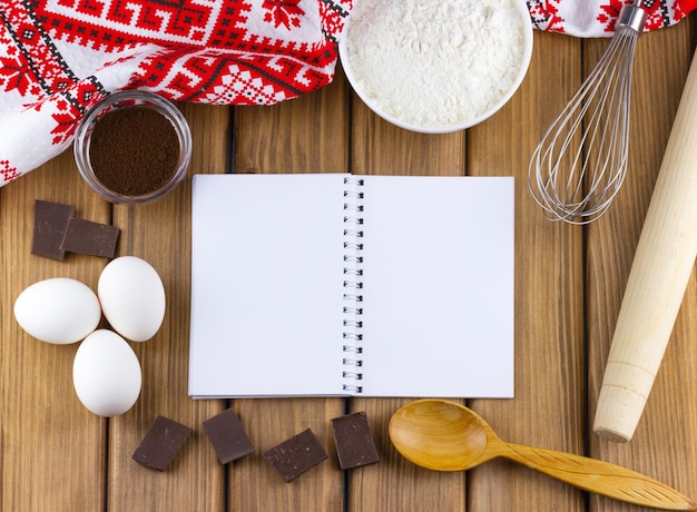 Empty notebook with food ingredients for cooking