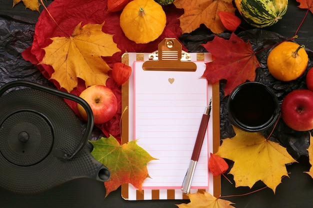 Empty notebook with maple leaf, apples and pumpkins