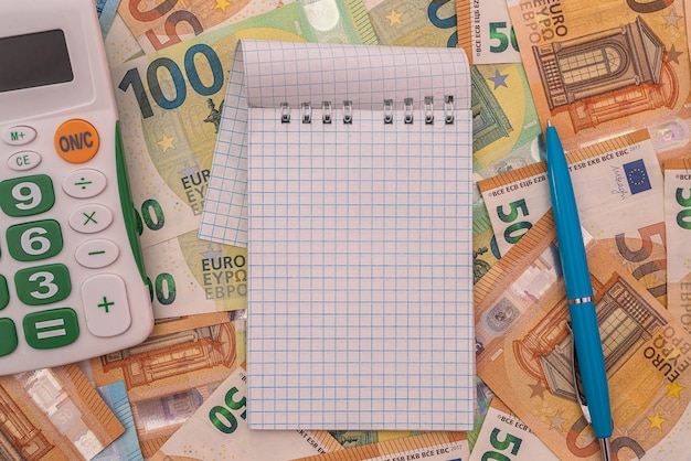 Empty notepad memo with pen on euro money. finance saving concept