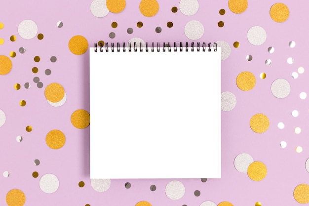 Empty notepad mockup on a purple pastel background Round confetti texture