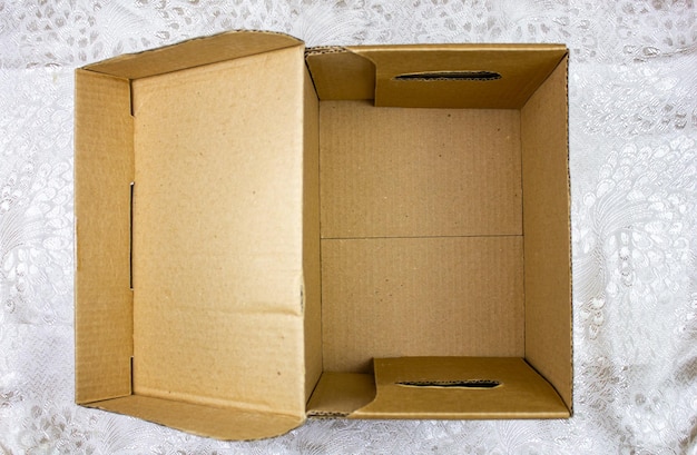 Empty open cardboard box with a bottom Cardboard packaging for things or objects on a light background Empty cardboard box