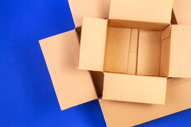 Empty open cardboard boxes on blue