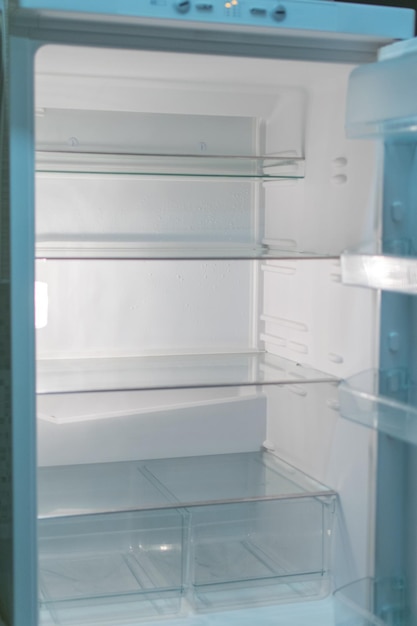 Empty open fridge with shelves refrigerator