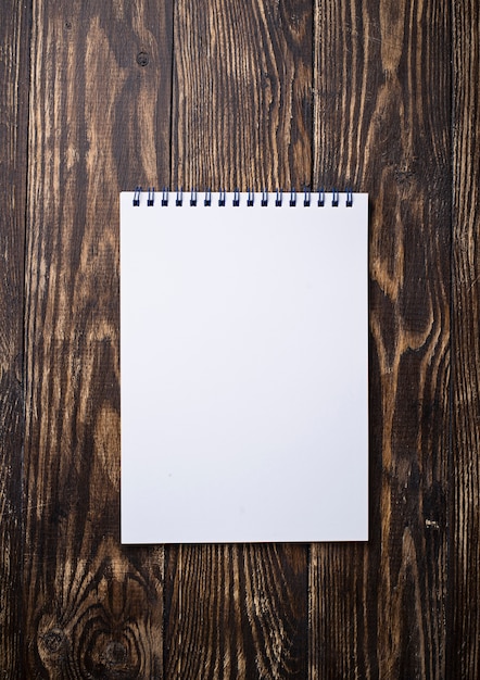 Empty open notebook on wooden surface