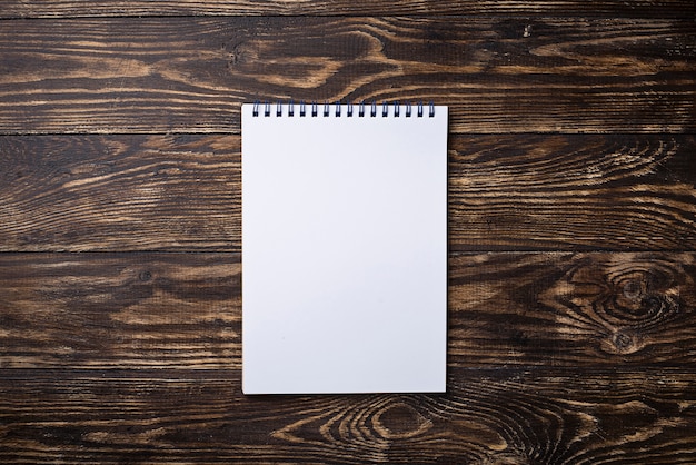 Empty open notebook on wooden surface