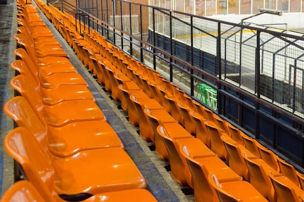 Empty orange seats at ice hockey stadium