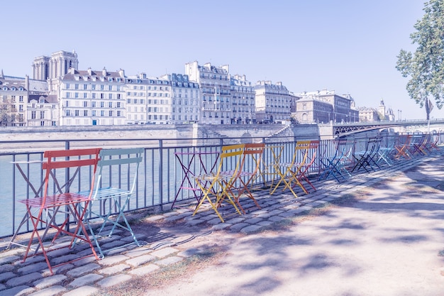 Empty outdoor cafe on the banks of the Seine, Paris, France.