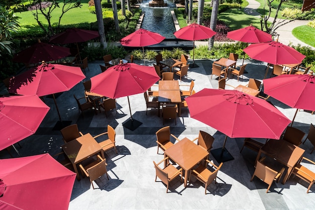 empty outdoor patio table and chair with umbrella