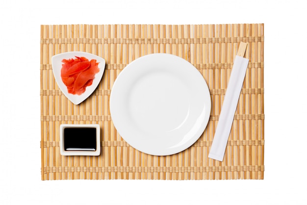 Empty oval white plate with chopsticks 