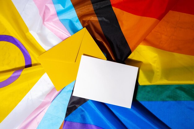 Empty paper blank on rainbow lgbtqia flag made from silk material mock up template copy space for