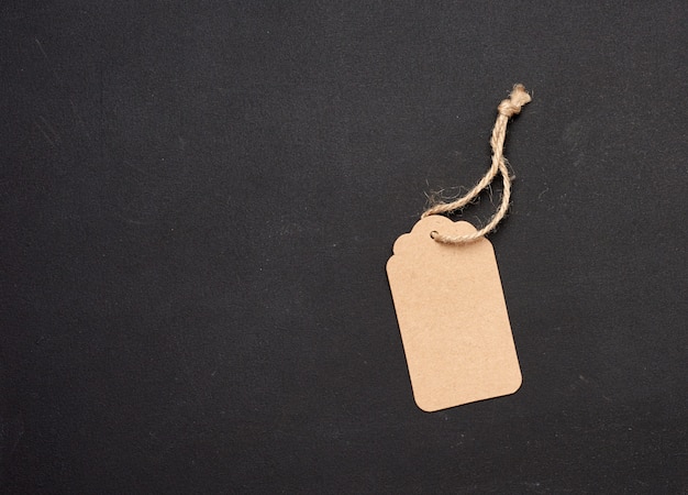 Empty paper brown rectangular price tag with rope