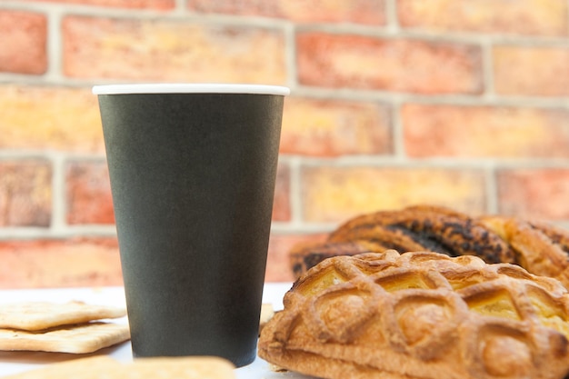 Empty paper cup mockup with pastries