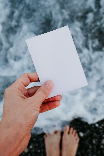 Empty paper note in hand at amazing landscape