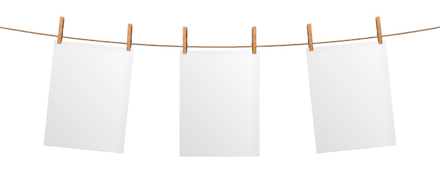 Photo empty paper sheet hanging on rope, isolated on white background