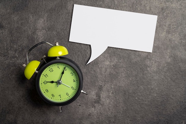 Empty paper with speech symbol and clock