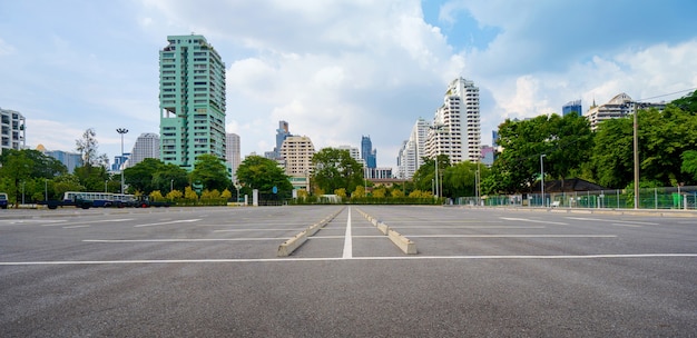 Empty parking lot with city in the background and beautiful blue sky