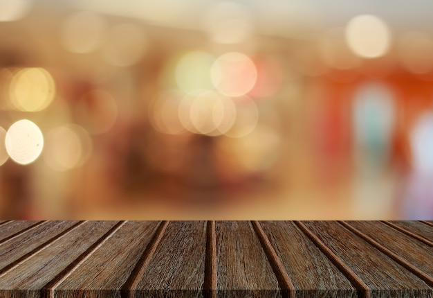 Empty perspective wood plank table top with abstract bokeh light background for montage of your product.