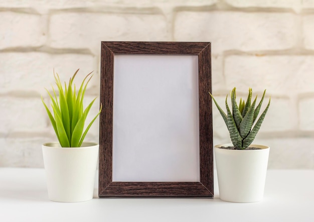 An empty photo frame in a dark frame on a table or shelf with a copy of the place.