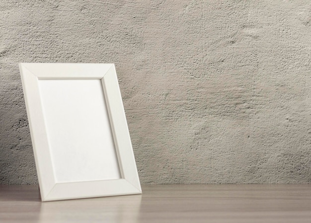 Empty photo frame on a table or shelf with a copy of the place